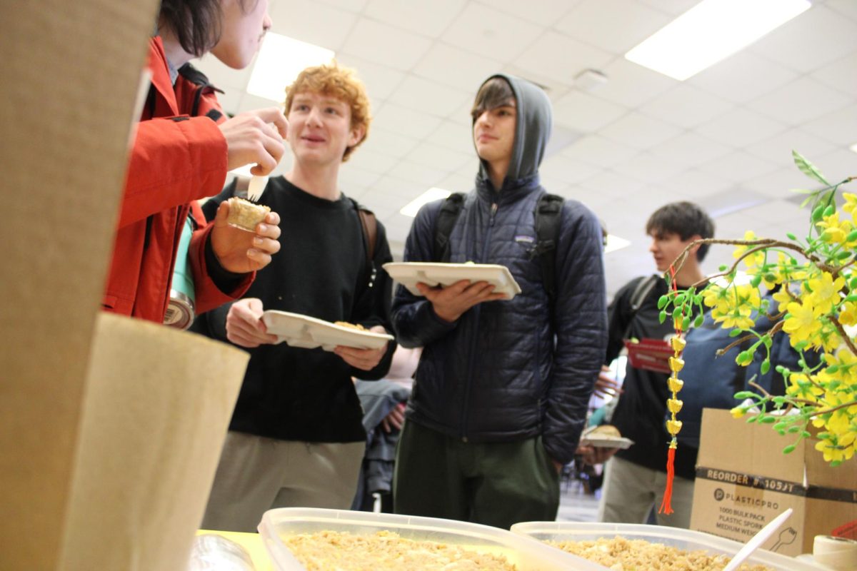 Quinnlan Felts (12), Lucas Hagan (11) and Isaac Marschall (11) try a variety of foods along with their school lunch. These students enjoyed fried rice at the AAPI booth.
