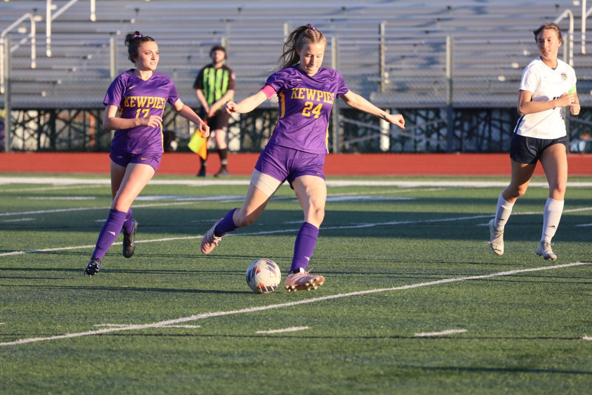 Lucy Elfrink (12) begins to pass the ball on Senior Night against Battle