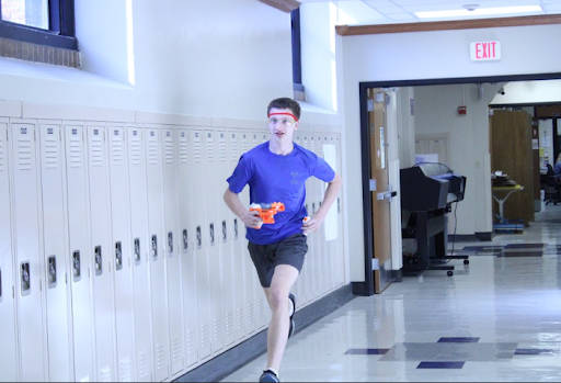 Garret Smith (9) runs down the hallway with his Nerf gun during a ZDL meeting. Picture taken by Juan Jackson.