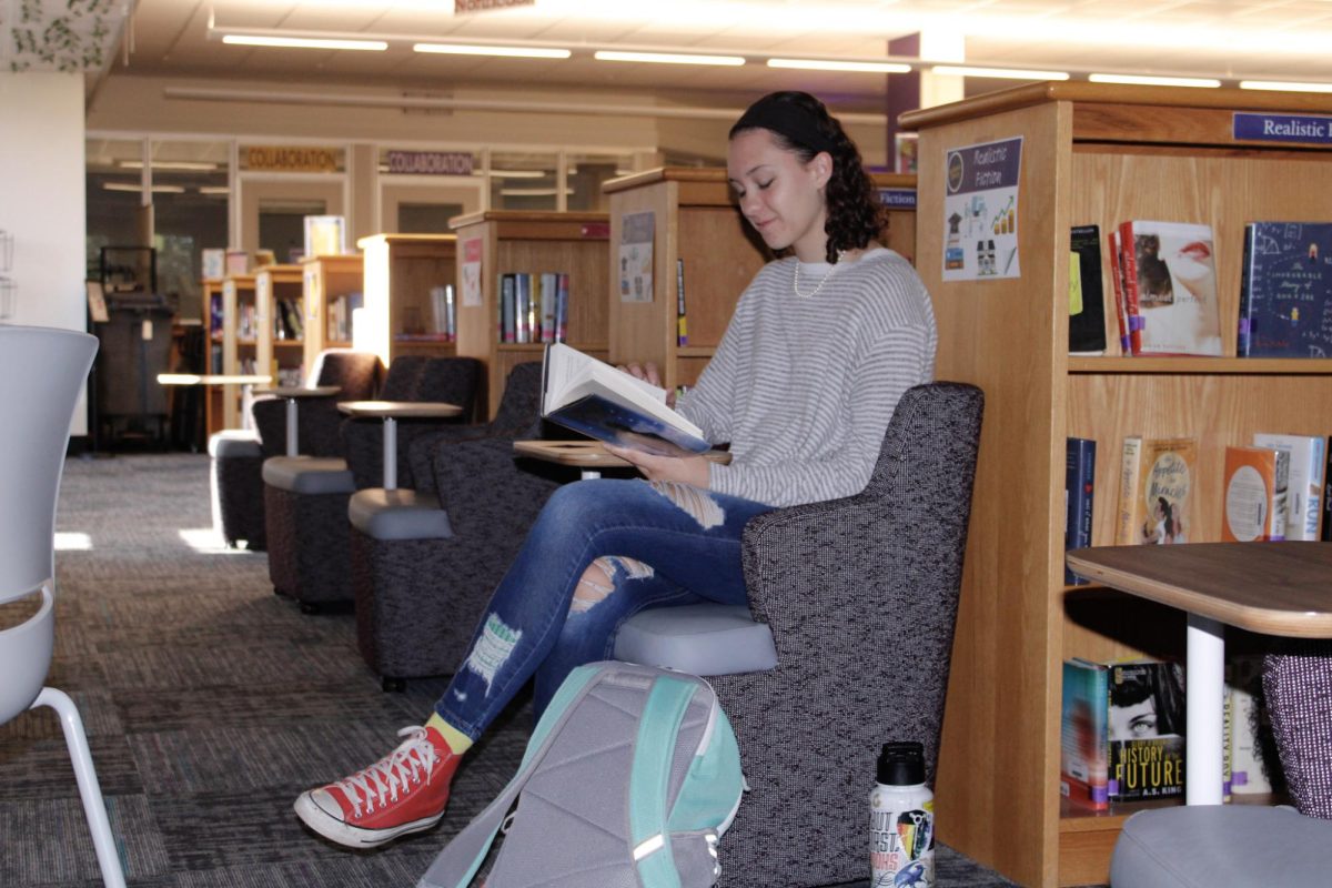 Junior Fifer Matteson reads in the silent section of the Library before school on Sept. 16.