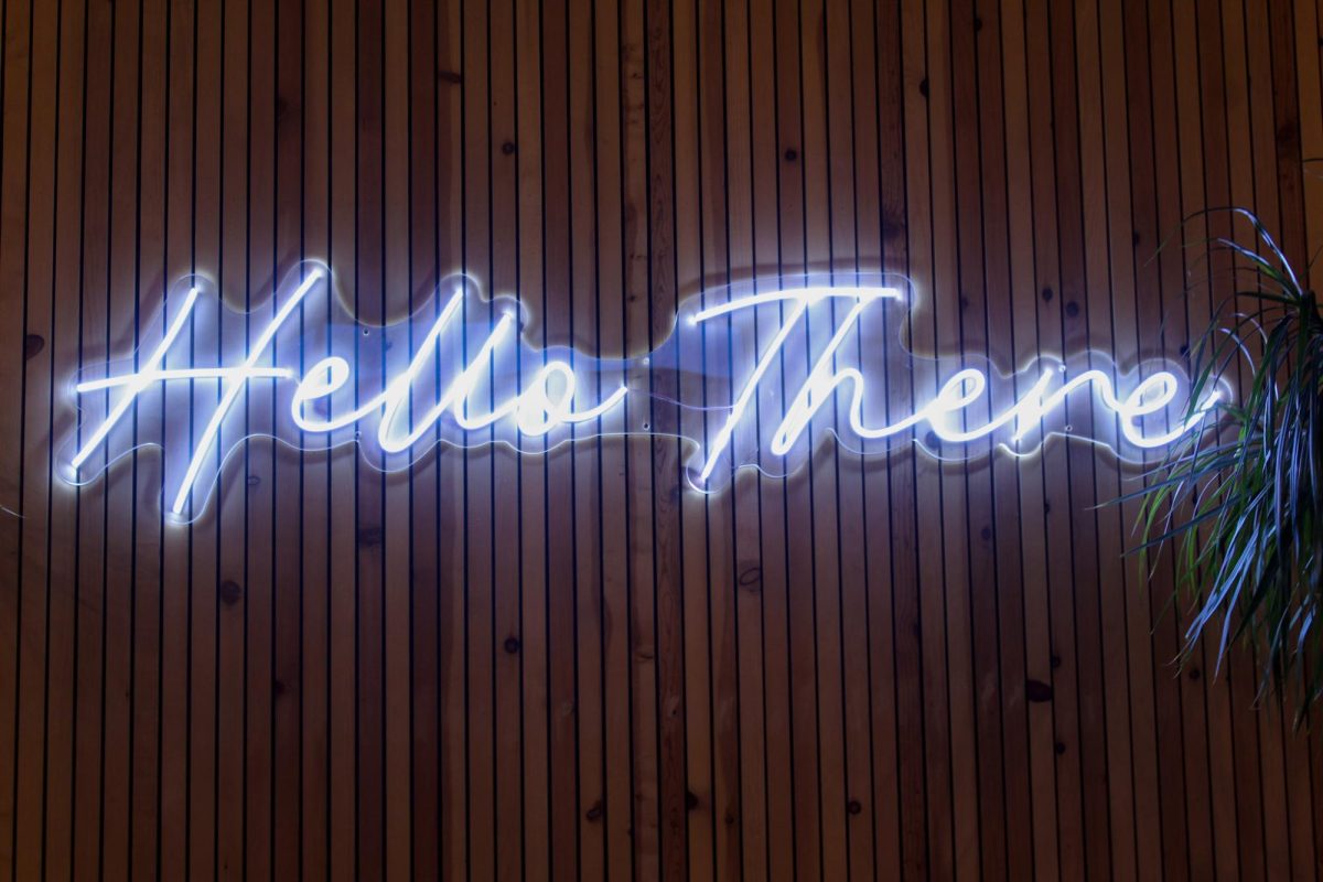 The “Hello There” neon sign hangs above a coach in one of the rooms added on to Acola when they expanded. “Hello There” is Acola’s slogan. Photo taken on Dec. 14. 