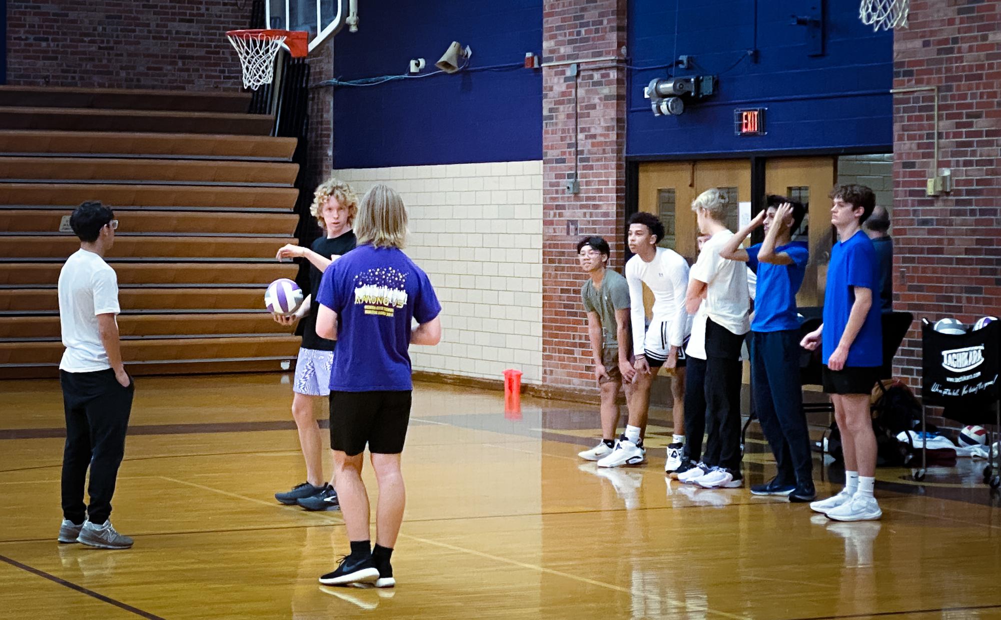 At the first open practice in the Old Gym on Dec. 4, Stokley Wexler (12) coaches new students.