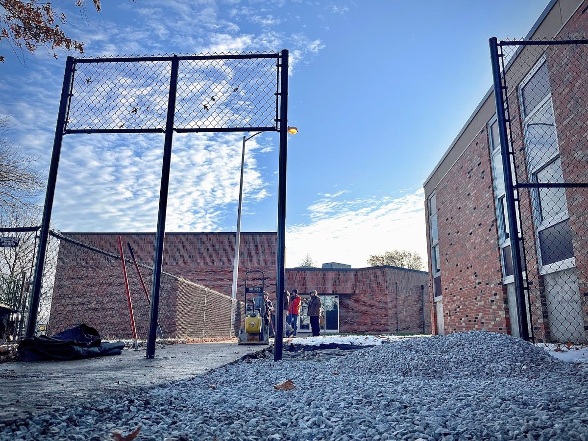 CPS Facilities workers lay gravel to prepare to pour concrete on Dec. 4 