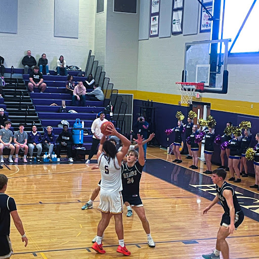 Brock Camp (12) pivots during Hickman's overtime win against Helias Tuesday, Jan. 28, 2024.