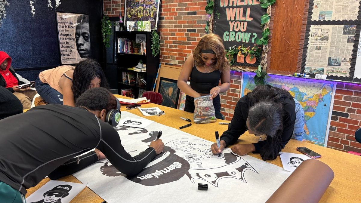 N’ya Fritz’s class works on a facial mural door decoration for classroom 249 on Feb. 13.