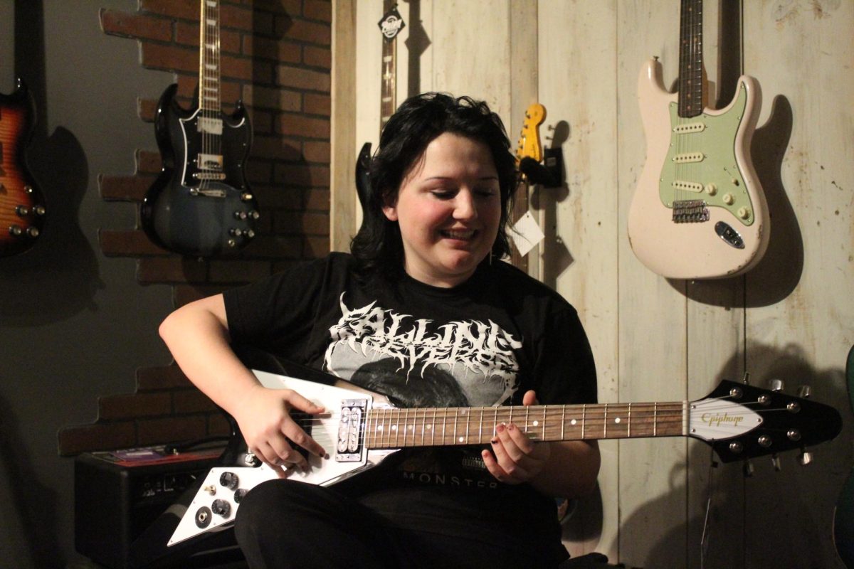 Adrian Martin playing an electric guitar (Harper Boyt)