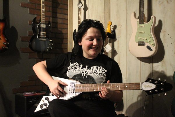 Adrian Martin playing an electric guitar (Harper Boyt)