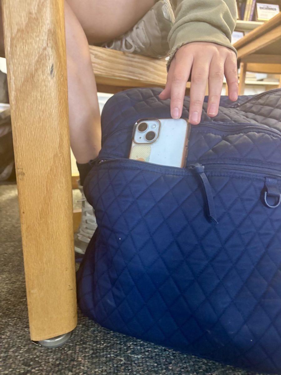 A student reaches for their phone during the school day