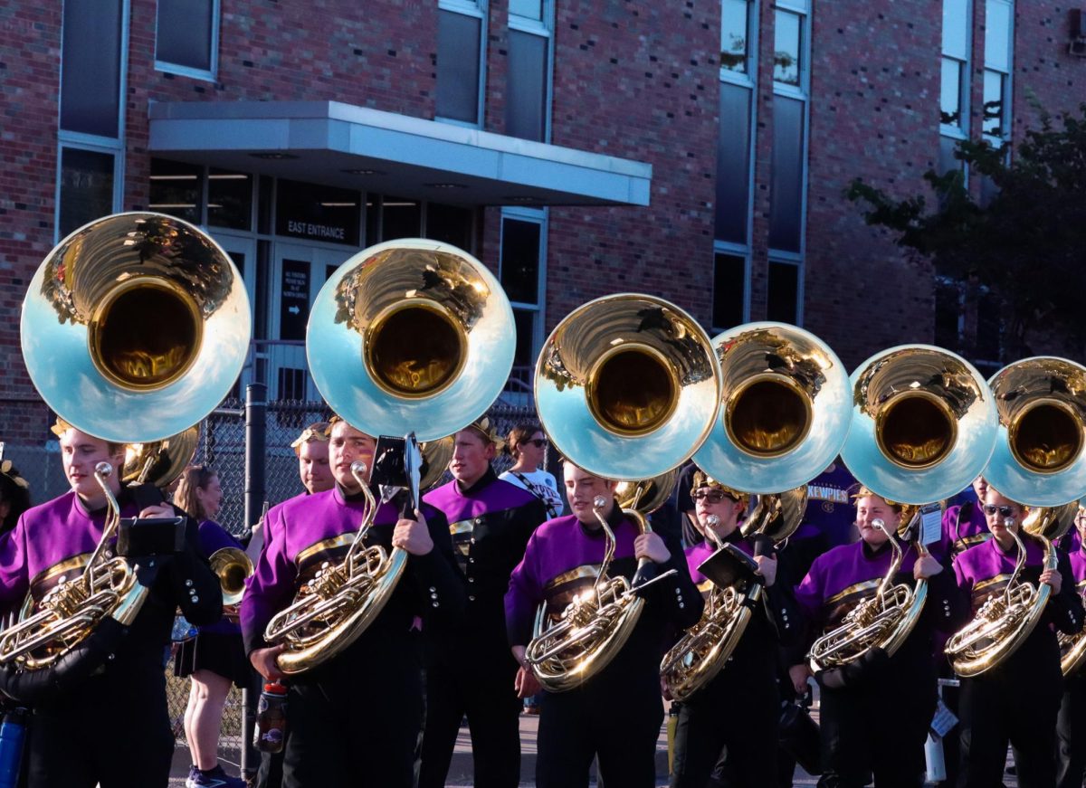 The tuba section stands in line waiting to file in to the football field