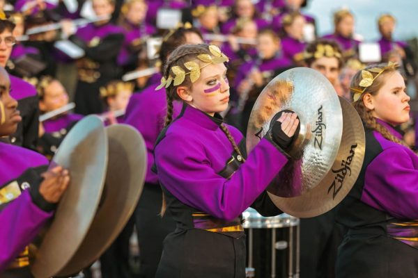 Kris Brooks playing cymbals during one of Hickman's football games. Being involved in band classes has become a pillar of her life. It has allowed her to give back to her community.